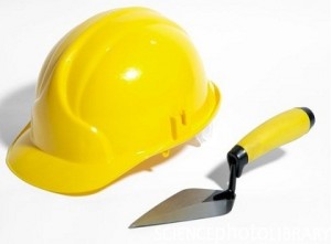 Bricklayer's hard hat and trowel.